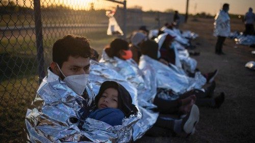 Dustin, an asylum-seeking migrant from Honduras, holds his six-year-old son Jerrardo, 6, as they ...