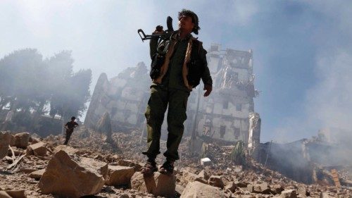 Huthi rebel fighters inspect the damage after a reported air strike carried out by the Saudi-led ... Huthi rebel fighters inspect the damage after a reported air strike carried out by the Saudi-led ...
