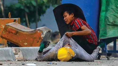 TOPSHOT - A protester holds onto the shirt of a fallen comrade, during a crackdown by security ...