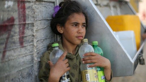 A Palestinian girl waits to fill bottles with water from a public tap in the southern Gaza Strip ... A Palestinian girl waits to fill bottles with water from a public tap in the southern Gaza Strip ...