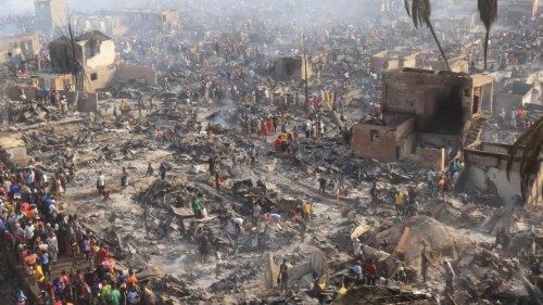 People look on at the aftermath of a large fire that broke out in an informal settlement in Susan?s ...