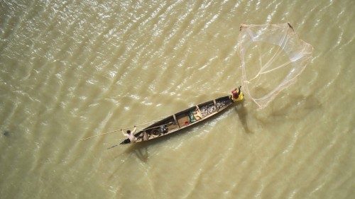 TOPSHOT - An aerial view shows a fisherman on a pirogue on the Bani river in Mopti on March 17, ...