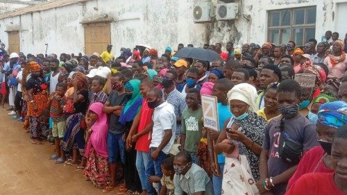 People wait for friends and relatives as a ship carrying more than 1,000 people fleeing an attack ...