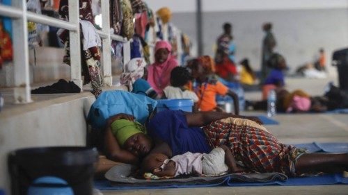 (FILES) In this file photo taken on April 02, 2021 A woman rests with her baby on the ground at the ... (FILES) In this file photo taken on April 02, 2021 A woman rests with her baby on the ground at the ...