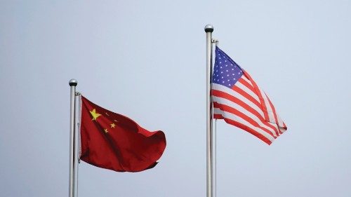 Chinese and U.S. flags flutter outside a company building in Shanghai, China April 14, 2021. ...