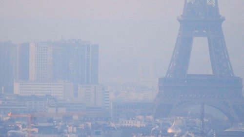 FILE PHOTO: The Eiffel Tower is surrounded by a small-particle haze which hangs above the skyline in ...