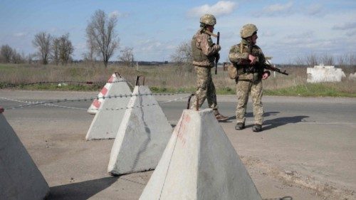 Ukrainian servicemen patrol at the checkpoint in the village of Shyrokyne near Mariupol, the last ...