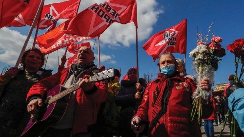 epa09171103 Members of Russian Communist party hold Red flags and sing as they take part in the ...