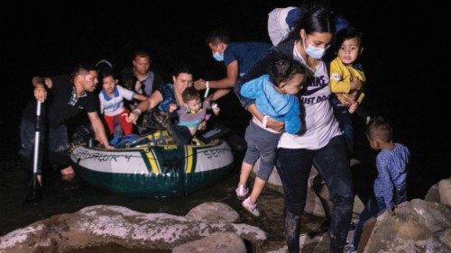 ROMA, TEXAS - APRIL 30: An immigrant mother carries her children up the bank of the Rio Grande after ... ROMA, TEXAS - APRIL 30: An immigrant mother carries her children up the bank of the Rio Grande after ...