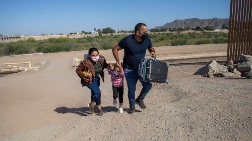 YUMA, AZ - MAY 13: A family of asylum seekers from Cuba cross an open section of wall at the ...