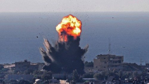 TOPSHOT - Smoke billows from an explosion as another air bomb (top) falls during an Israeli air ...