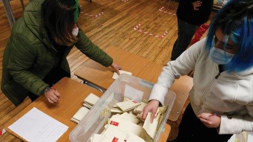 Poll workers count ballots after polls closed during the elections for governors, mayors, ...