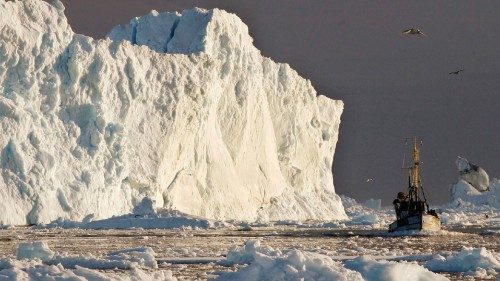 FILE PHOTO: A fishing boat sails past a large iceberg at the mouth of the Jakobshavns ice fjord near ... FILE PHOTO: A fishing boat sails past a large iceberg at the mouth of the Jakobshavns ice fjord near ...