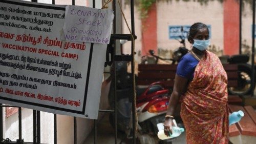 A woman walks past a notice announcing unavailability of Covaxin Covid-19 coronavirus vaccine doses ...