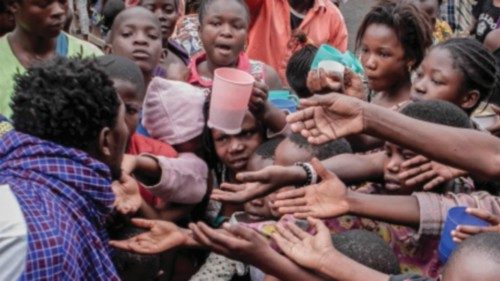 Displaced residents of Goma, queue to receive food distributed by the citizen's movement 'Lucha' as ...