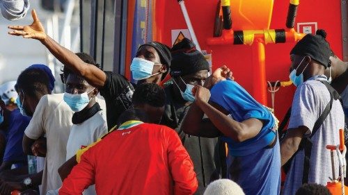 Migrants wait to disembark from a Spanish coast guard vessel in the port of Arguineguin, on the ...