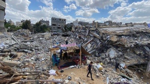 A Palestinian boy from Zawaraa family walks near their makeshift tent amid the rubble of their ...