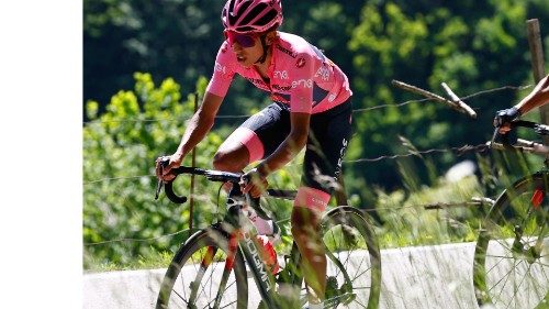 Overall leader Team Ineos rider Colombia's Egan Bernal (L) rides through the Passo di San Valentino ...