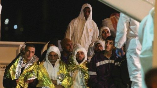 Migrants wait to disembark from a ship on March 4, 2015 after a rescue operation off the coast of ...