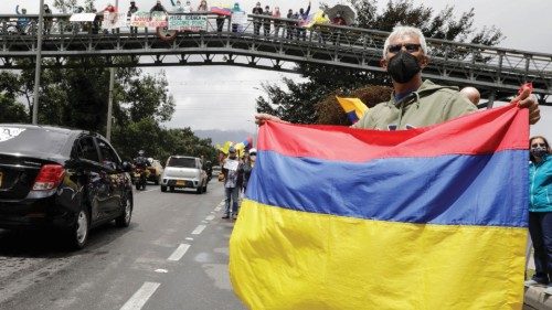 epa09251912 Protesters with banners and flags of Colombia gather on the road that leads to the El ...