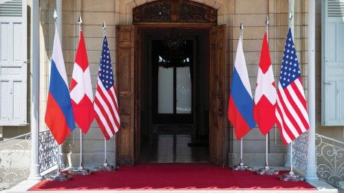 Flags of the U.S., Russia and Switzerland are pictured in front of the entrance of villa La Grange, ...
