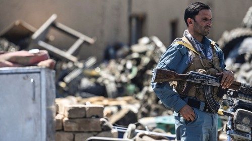 In this picture taken on June 17, 2021, a policeman stands guard at a junkyard near the Bagram Air ...