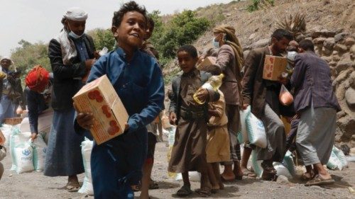 epa09281420 Yemenis get their families? food aid provided by Mona Relief Yemen, amid a humanitarian ...