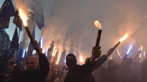 Activists of nationalists movements light flares and shout slogans during a rally in Kiev on October ...