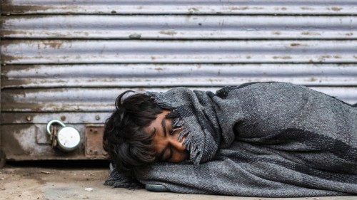 A man sleeps in front of a closed shop during a government-imposed lockdown forced to prevent the ... A man sleeps in front of a closed shop during a government-imposed lockdown forced to prevent the ...