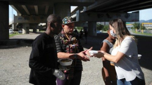 Jeniffer Faria, a member of the Institute doAcao, delivers food and bread to homeless people, which ...