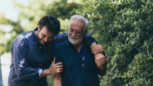 The old man and his son are walking in the park. A man hugs his elderly father. They are happy and ... The old man and his son are walking in the park. A man hugs his elderly father. They are happy and ...