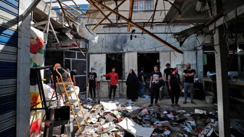 Iraqis inspect the site of the explosion a day earlier in a popular market in the Shiite-majority ... Iraqis inspect the site of the explosion a day earlier in a popular market in the Shiite-majority ...