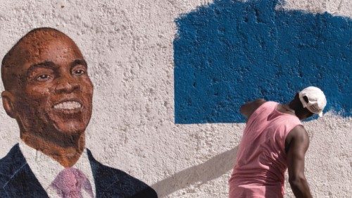 epa09353947 A man paints a mural in tribute to the assassinated President Jovenel Moise, in ...