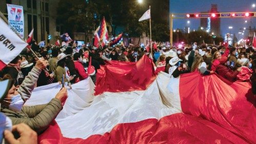 Supporters of leftist school teacher Pedro Castillo celebrate with a giant Peruvian flag in dowtown ...