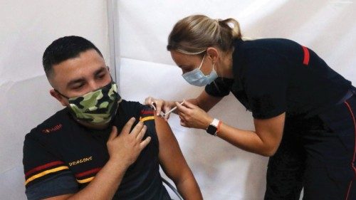 A man receives a dose of a Covid-19 vaccine at a vaccination center in Perpignan, southern France, ...