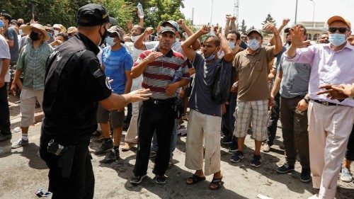 A police officer gestures as supporters of Tunisia's biggest political party, the moderate Islamist ...