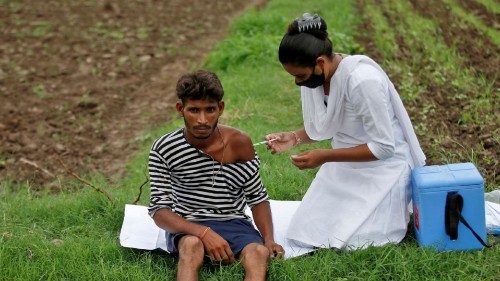 FILE PHOTO: Healthcare worker Jankhana Prajapati gives a dose of the COVISHIELD vaccine against the ...