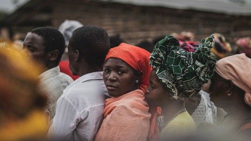 Residents gather for a distribution of utensils organised by the Catholic relief organisation ...