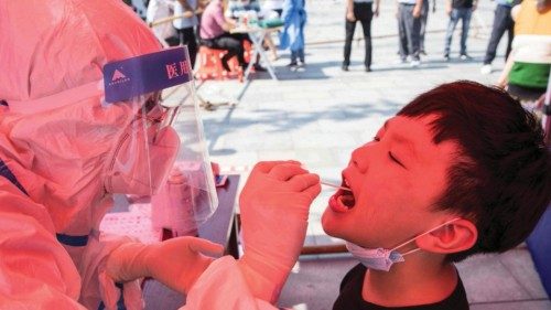 The photo taken on July 30, 2021 shows a boy receiving nucleic acid testing for the Covid-19 ...