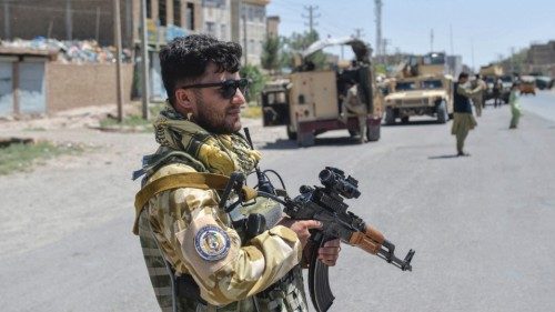 An Afghan National Army commando stands guard along the road in Enjil district of Herat province on ...