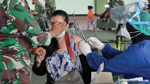 A woman receives the Sinovac Covid-19 coronavirus vaccine at a makeshift mass vaccination clinic in ...