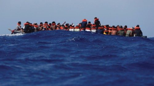 Some 89 migrants on a wooden boat wait to be rescued during a joint rescue operation between the ...