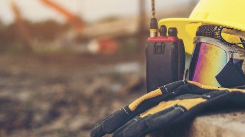Yellow helmets, gloves, radio communication and safety glasses placed on the cement floor are the ... Yellow helmets, gloves, radio communication and safety glasses placed on the cement floor are the ...