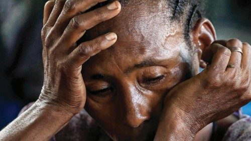 A woman reacts as she sits at a camp for Ethiopian refugees of the Qemant ethnic group in the ...