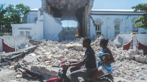 TOPSHOT - People drive past the remains of the 'Sacré coeur des Cayes' church in Les Cayes on August ...