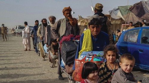 Afghan nationals queue up at the Pakistan-Afghanistan border crossing point in Chaman on August 17, ...
