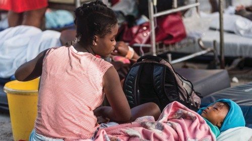 TOPSHOT - A young mother looks on at her daughter, injured as a result of the earthquake at the ...