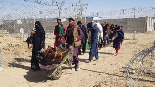 TOPSHOT - Afghan nationals cross the border into Pakistan at the Pakistan-Afghanistan border ...