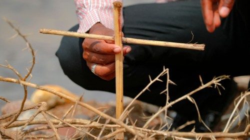 A Tigrayan refugee places a makeshift cross on the banks of the Setit river bordering Ethiopia, at ... A Tigrayan refugee places a makeshift cross on the banks of the Setit river bordering Ethiopia, at ...