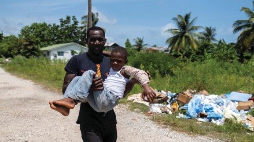 A man carries a boy injured after Saturday's 7.2 magnitude quake to receive medical attention at the ...